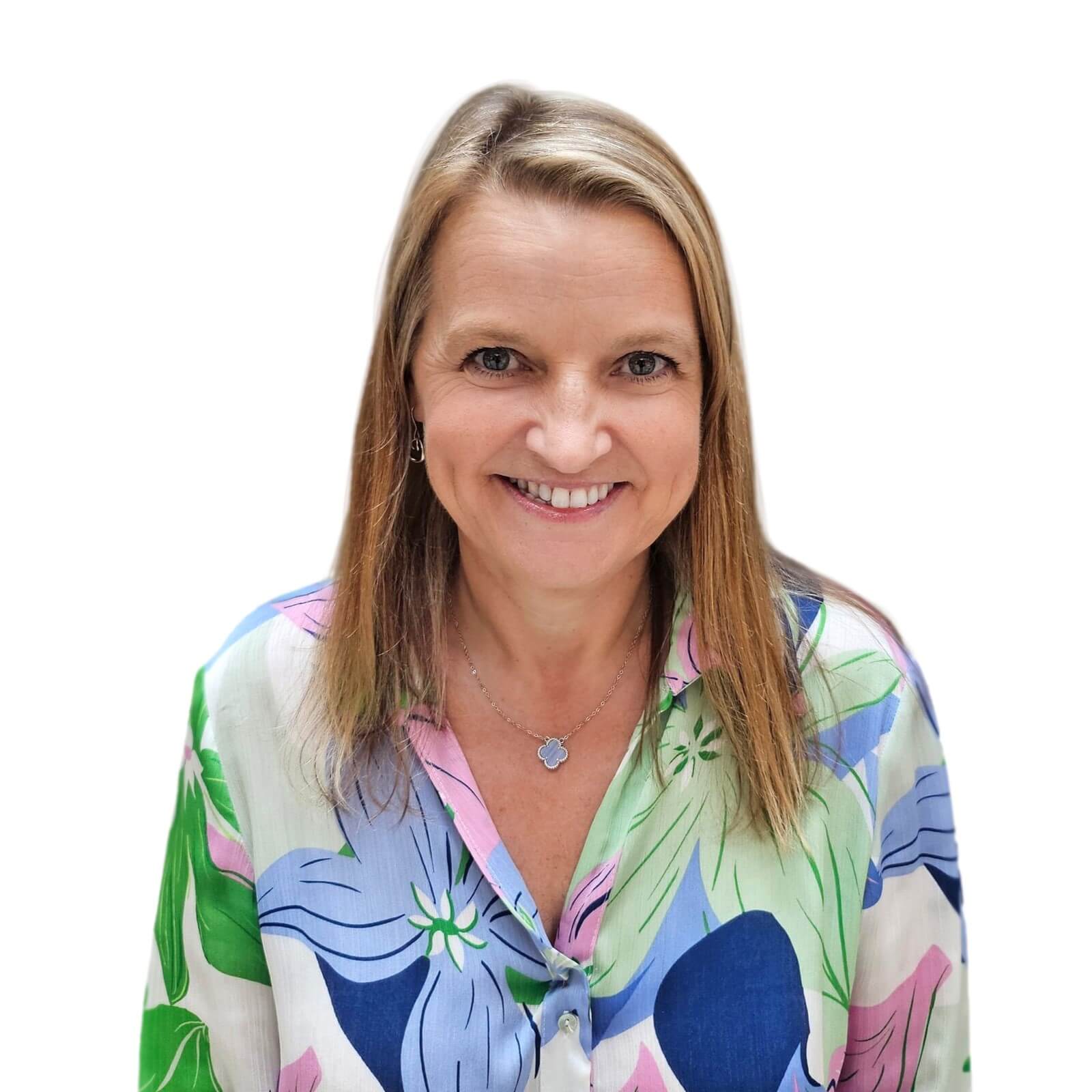 A woman with blonde hair wearing a vibrant, colorful shirt, smiling