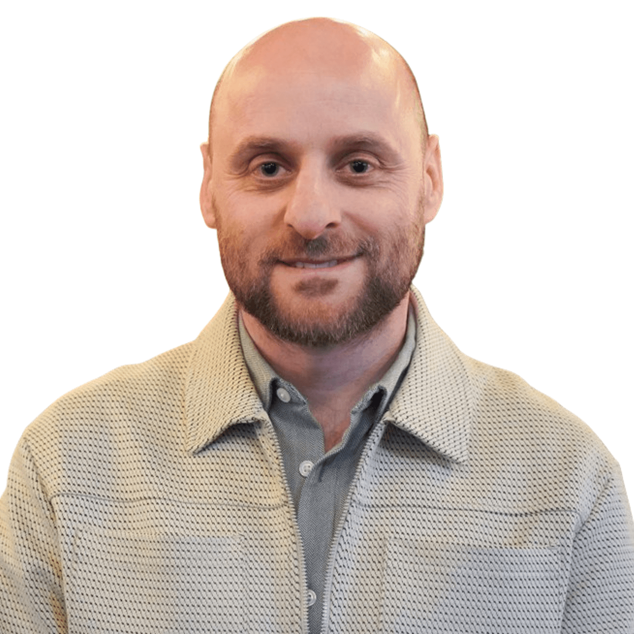 A bald man with a beard wearing a grey shirt under an off-white jacket, looking confidently at the camera.