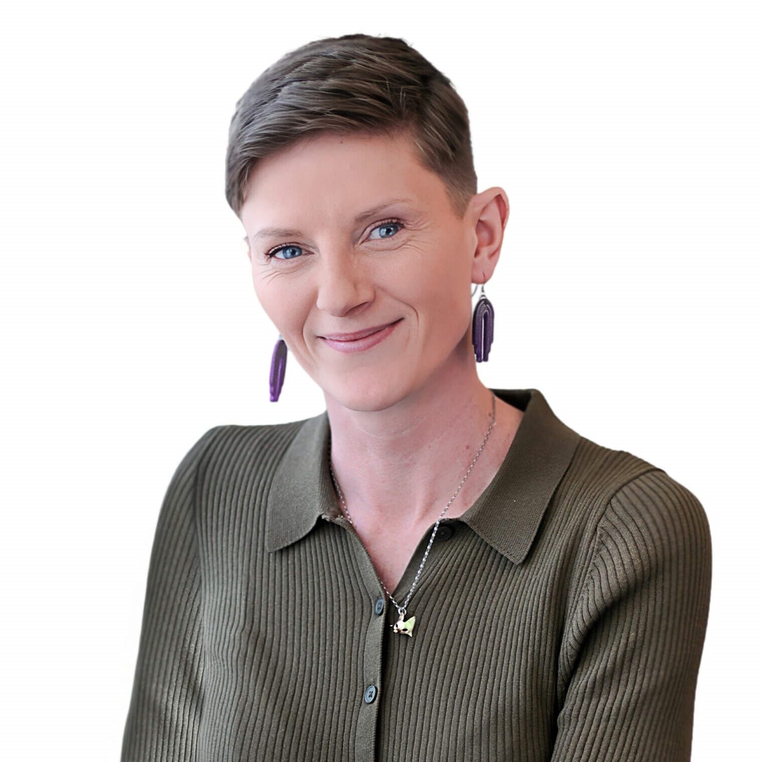 A woman with short hair wearing a green shirt, smiling and looking towards the camera.